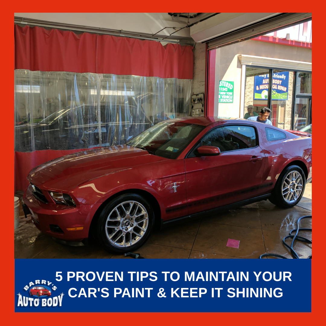 A shiny red Mustang car inside Barry's Auto Body Garage, showcasing a well-maintained glossy paint finish.