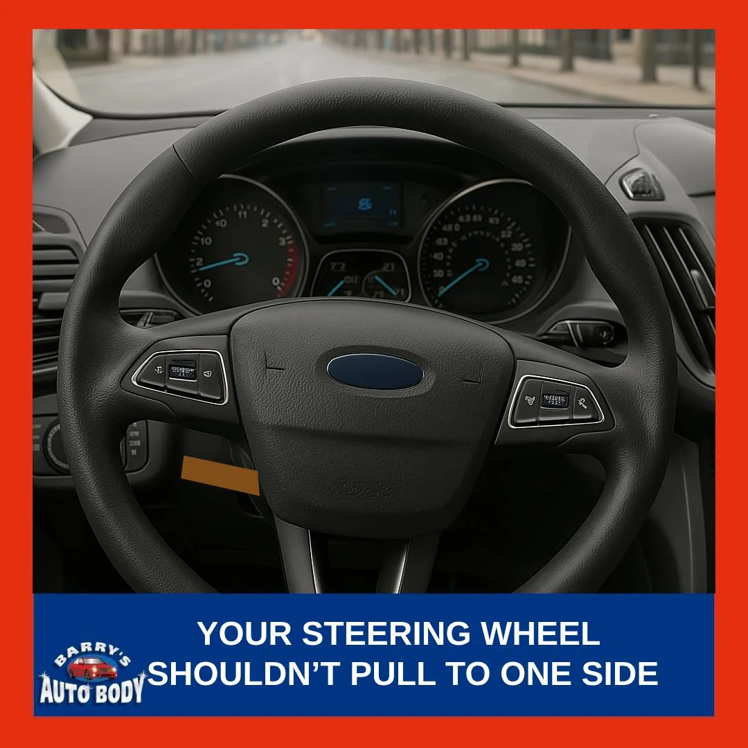 Car steering wheel slightly turned while driving straight on a city road, indicating alignment or suspension issue.