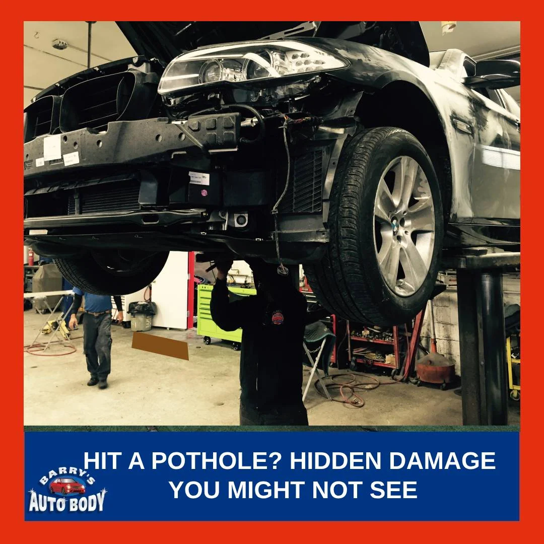 Close-up of a vehicle tire and technician inspecting the suspension system after hitting a pothole