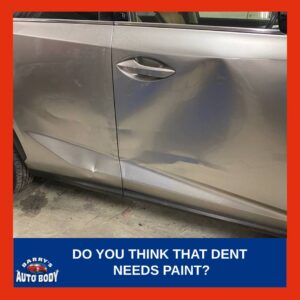 Technician planning to perform Paintless Dent Repair (PDR) on a vehicle's door panel