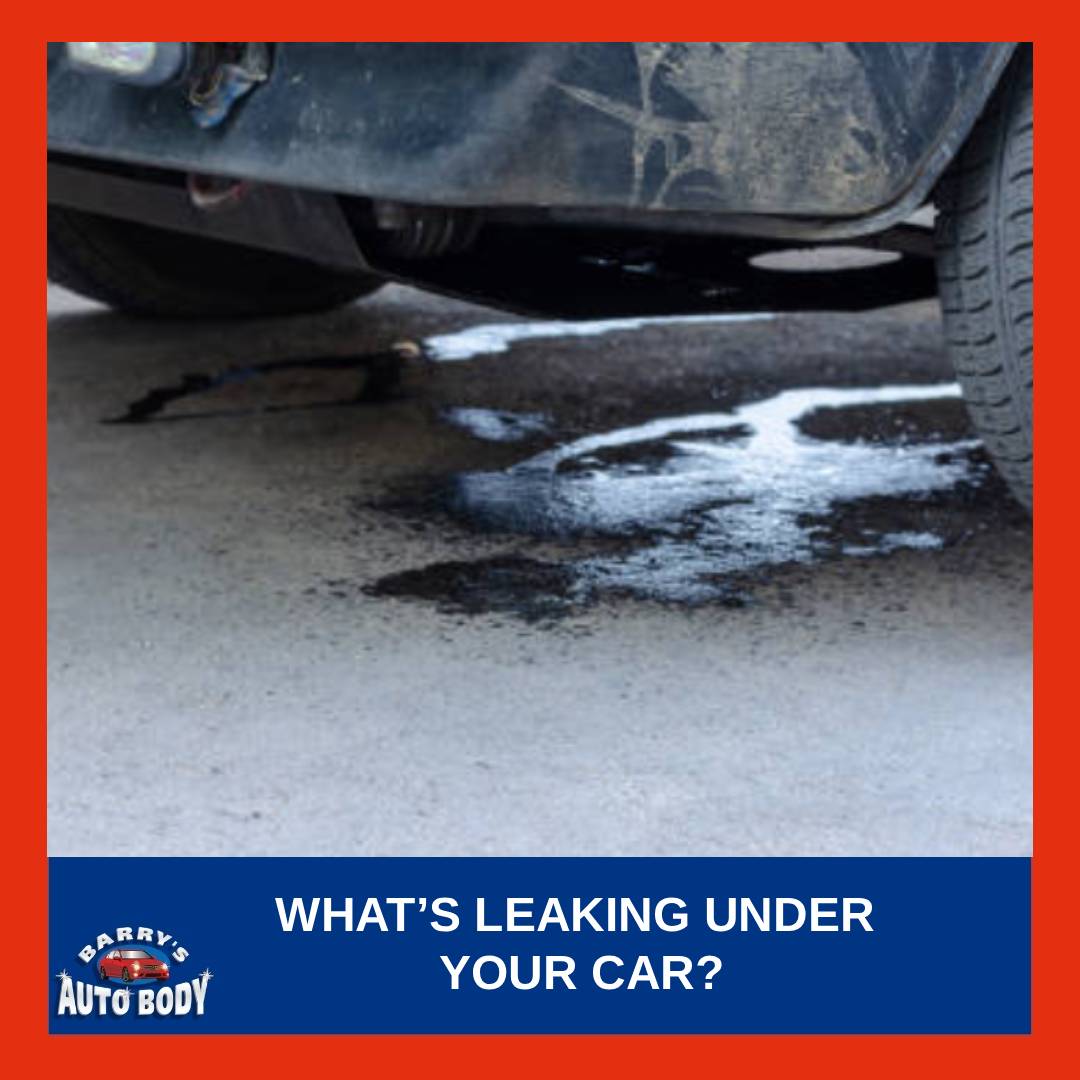 Puddle of fluid under a parked car showing possible engine, coolant, or brake leak