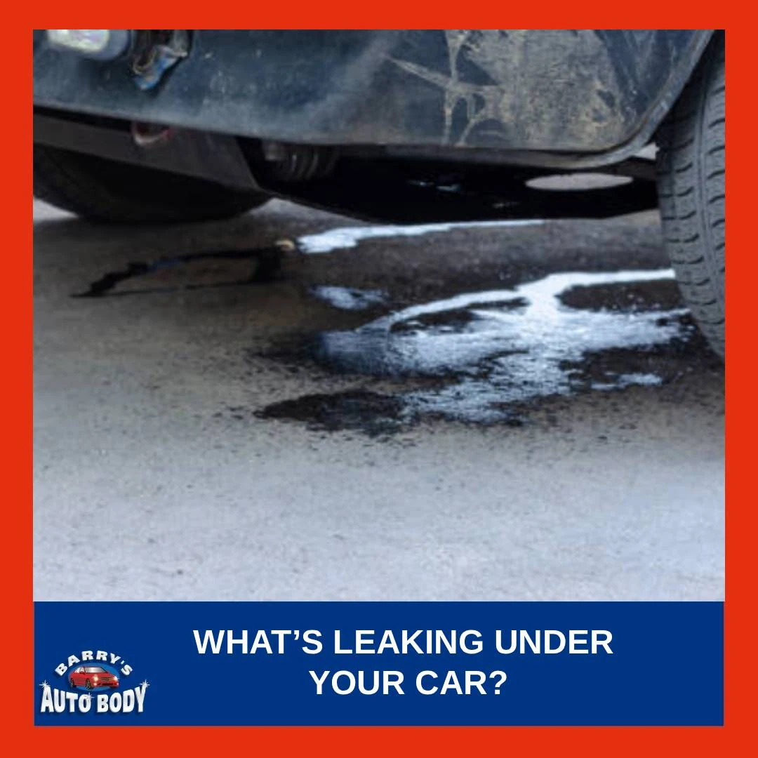 Puddle of fluid under a parked car showing possible engine, coolant, or brake leak