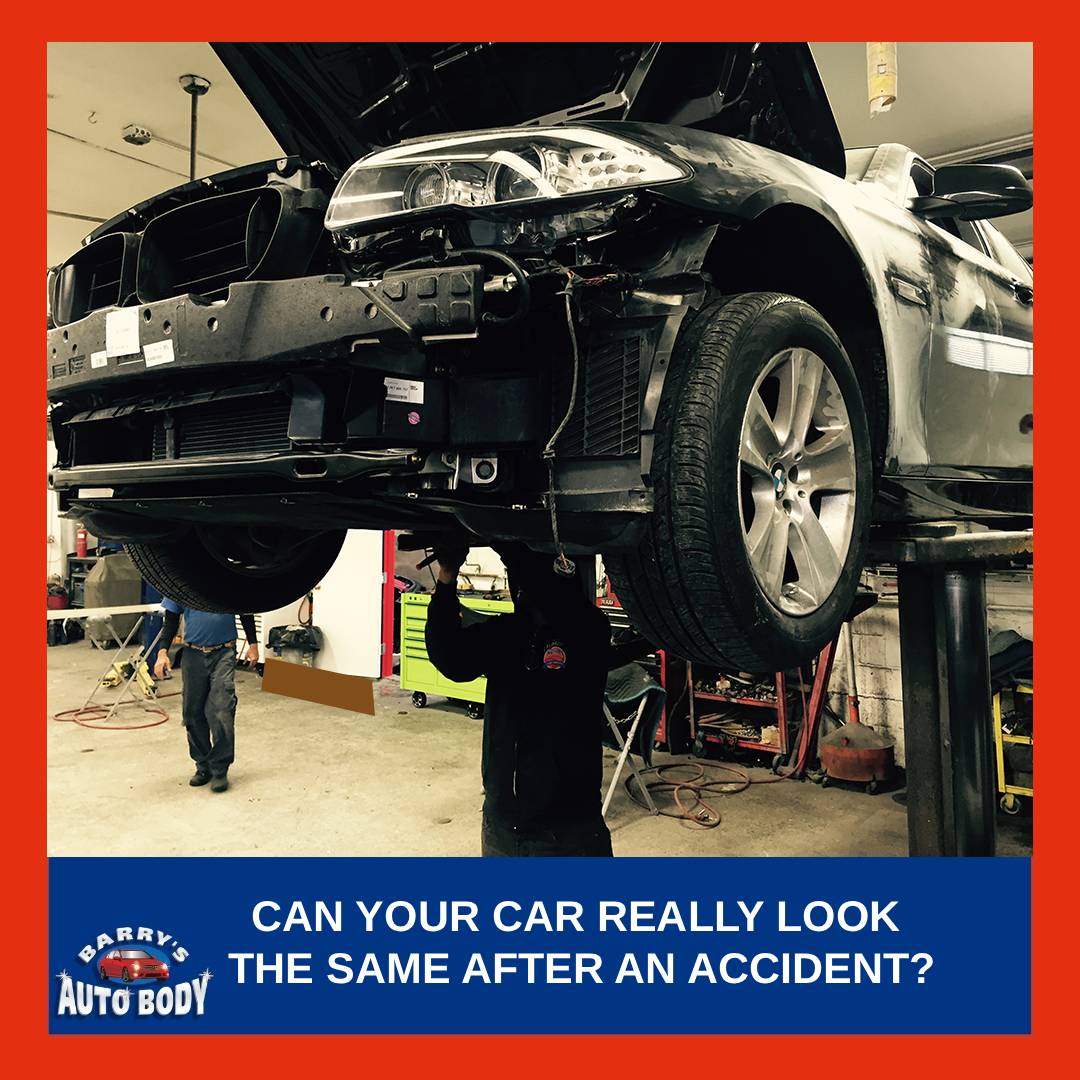 Auto body technician inspecting a repaired car panel after accident repair to check paint match and alignment